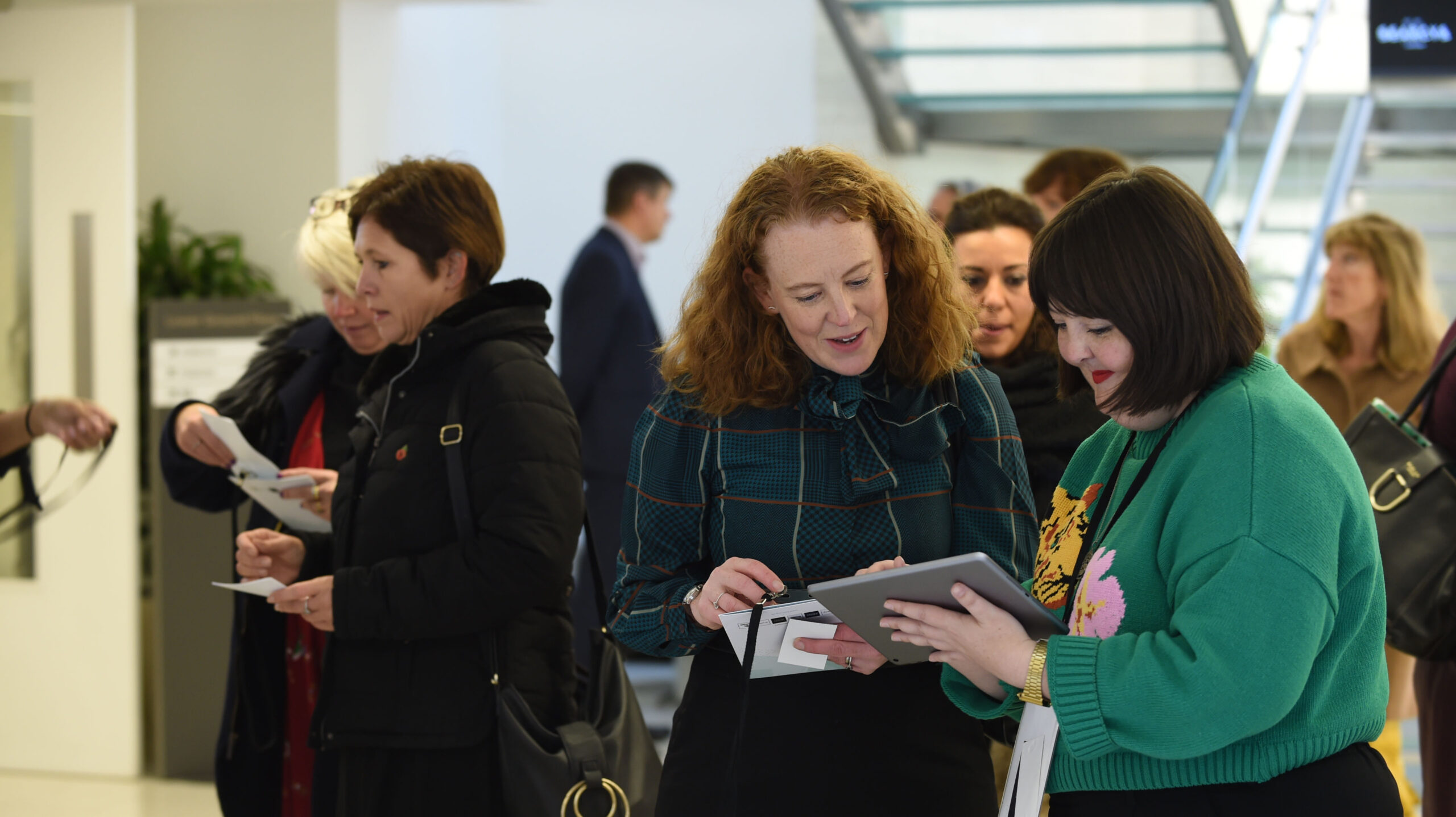 People at an open event looking at display stands