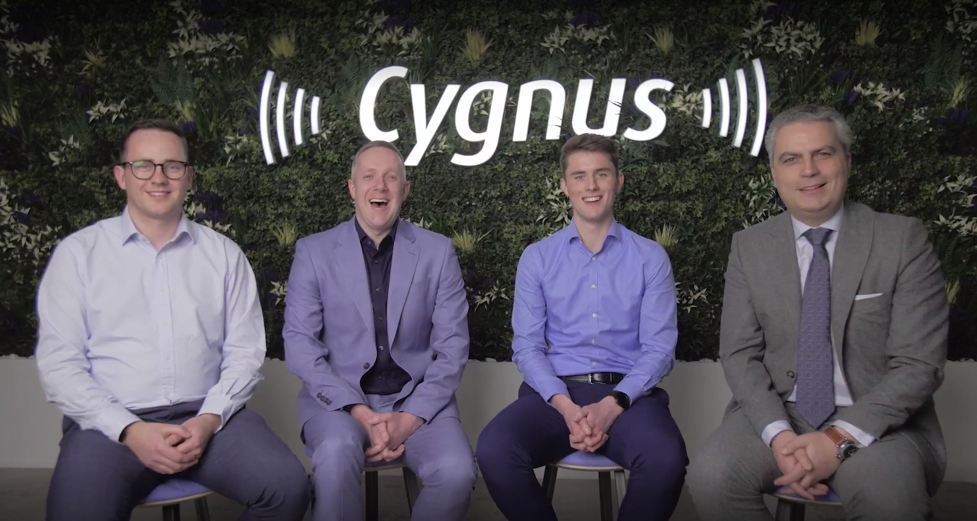 Cygnus team in front of living wall at launch event
